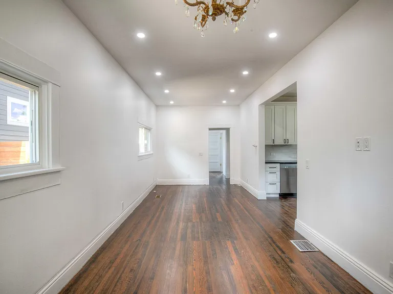 View of living room and dining room from front door.