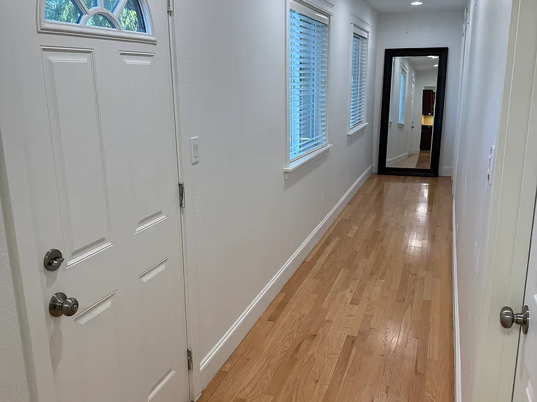 Hallway to 2nd bedroom, master bedroom, access to deck and 2nd full bathroom
