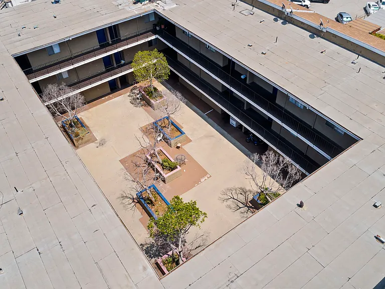 Aerial view highlighting the open courtyard and surrounding community layout.