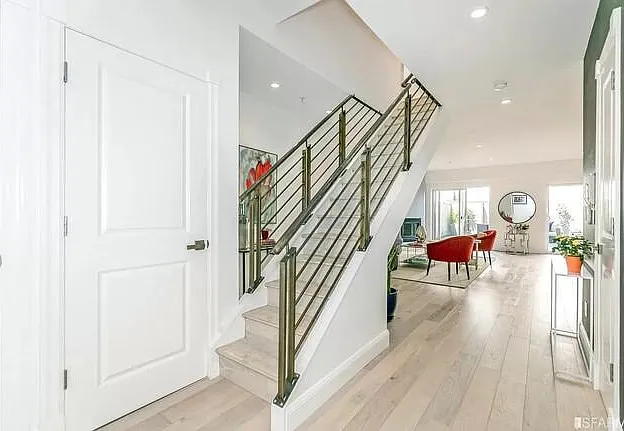 Stairs going up to the bedrooms. Washer+Dryer and extra storage on the left.