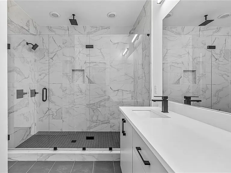 Main Bathroom (Note: Actual unit has light wooden floors and upgraded fixtures / appliances)