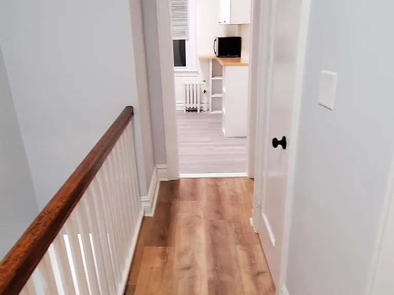 New flooring in the main hallway, looking toward the kitchen