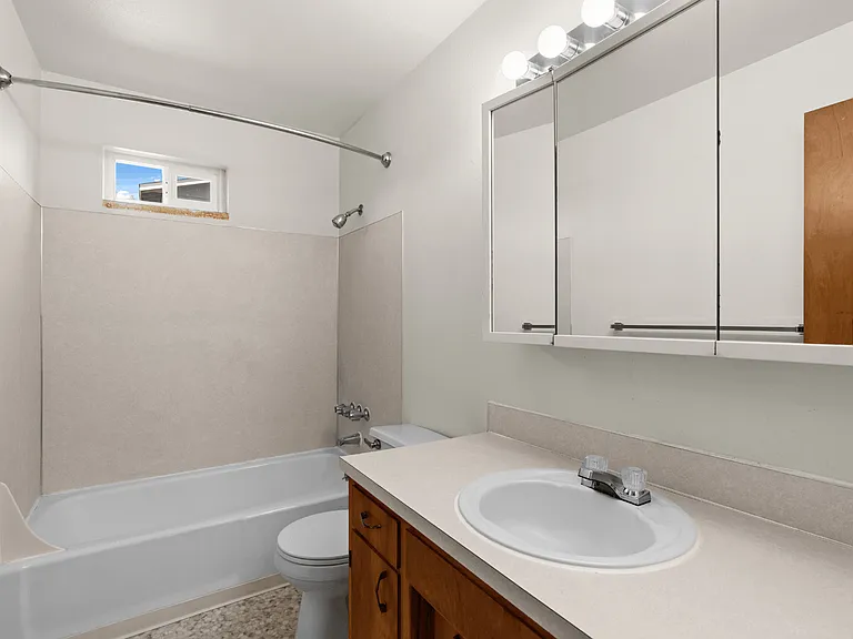 Full bathroom with a tub and shower combination in a one-bedroom deluxe apartment at Palisades Apartments in Tacoma. Full bathroom with a tub and shower combination in a one-bedroom deluxe apartment at Palisades Apartments in Tacoma.