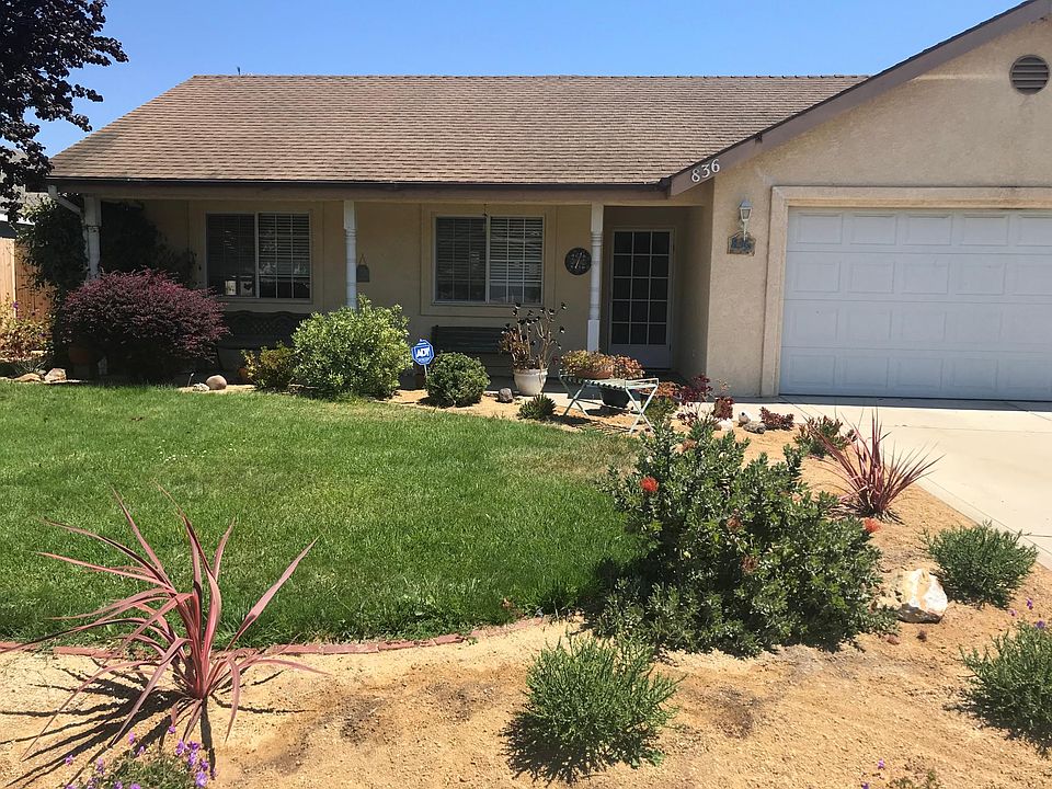 Front yard with covered patio area, 2 car garage with additional driveway parking