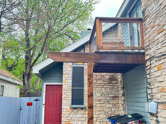 Front door with view of master balcony. Tall trees all around keep the unit cool in summers.