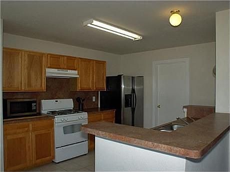 Kitchen boasts of much counter space and breakfast bar area.