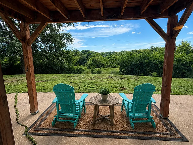 A simple outdoor rug transforms these Adirondack chairs into a cozy retreat_the perfect place to relax and unwind.