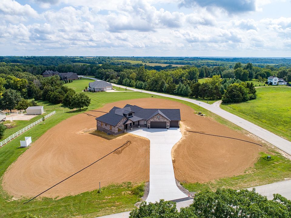 Angled ranch house plan with walk out basement and additional garage in back