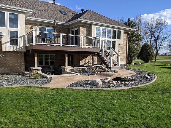 Custom rain proof deck with patio underneath. Water feature with ornamental pond.
