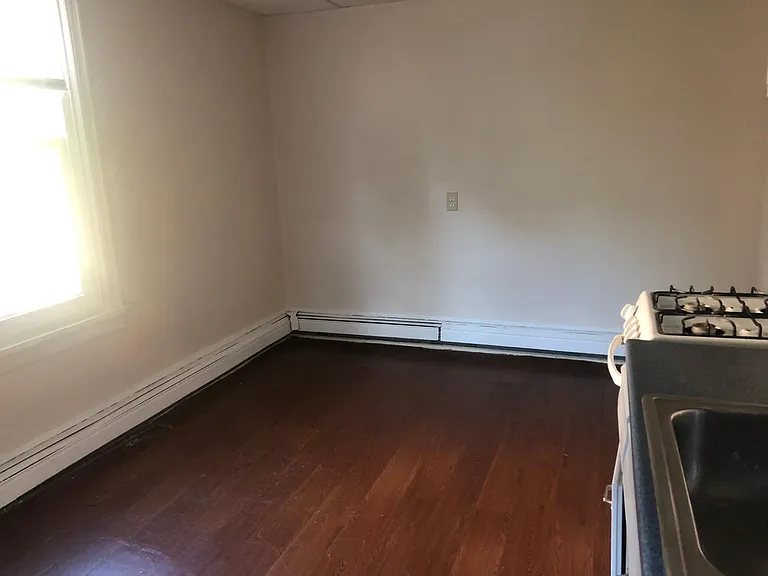 Large updated kitchen with dishwasher and two large windows.