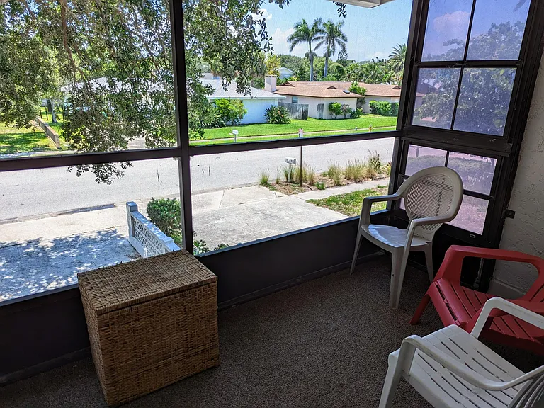 Second floor screened balcony accessible through front bedroom