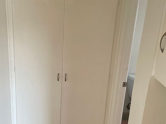 Hall linen closet with plenty of storage.
