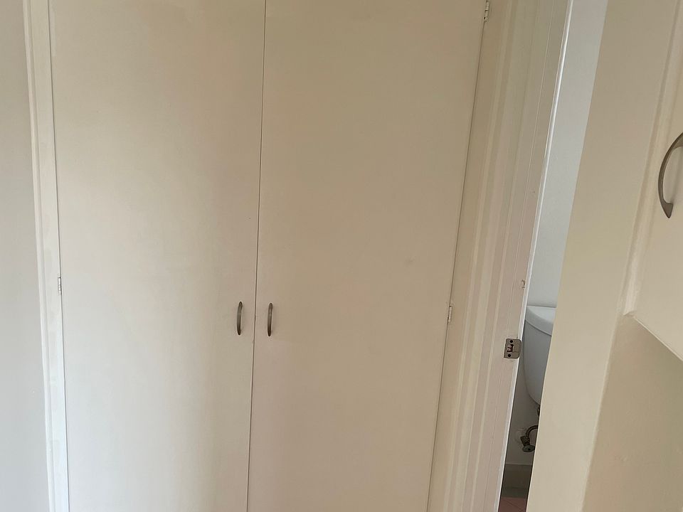 Hall linen closet with plenty of storage.