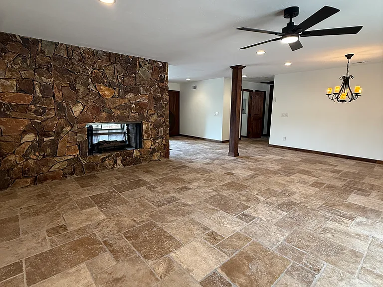 1 of 3 living spaces. This one has a view of the pool from double glass doors, a dual sided glass fireplace and adjoining dining area!