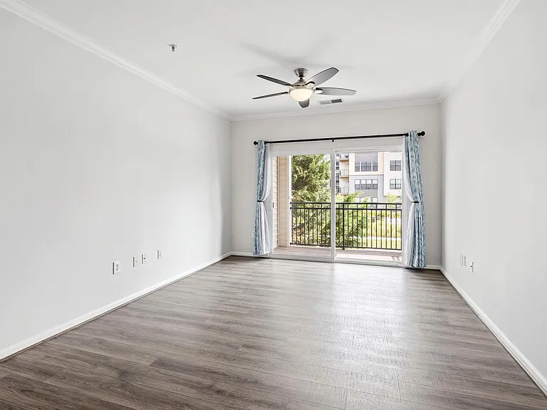 Living space and balcony with opposite park view