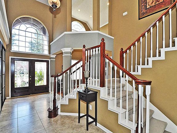 The dramatic entry boasts of spectacular views! From the 2 story entry, views of the pool, WOOD & TILE floors, a split staircase and more...your guests are sure to be impressed!