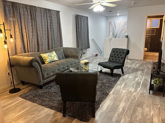 Living room facing stairs and bathroom