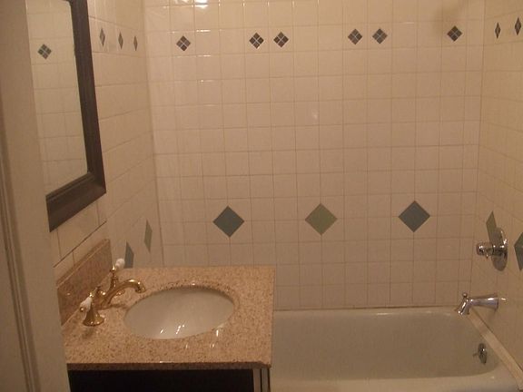 bathroom with granite top vanity