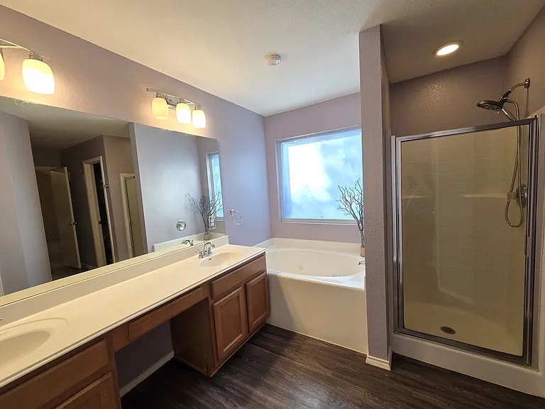 Primary bathroom with separate shower and jetted tub.