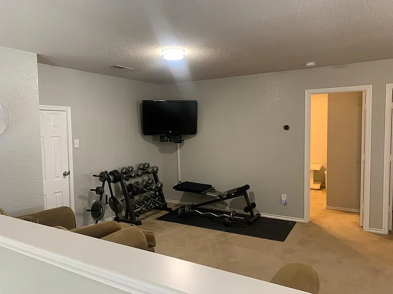 Upstairs has another flexible living area with workout equipment and furniture when you want to relax and stream a show or movie.