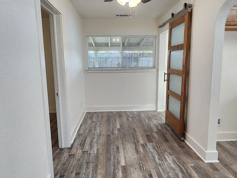 Dining area with sliding barn door to laundry room.