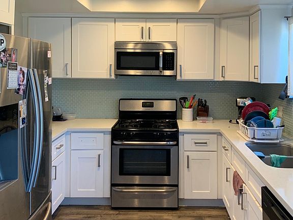 Updated kitchen with quartz countertops, tile backsplash, plenty of storage space, under-mount sink, and stainless steel appliances