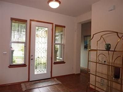 Gracious entry with a leaded detail glass door and easy to maintain decor tile floor.