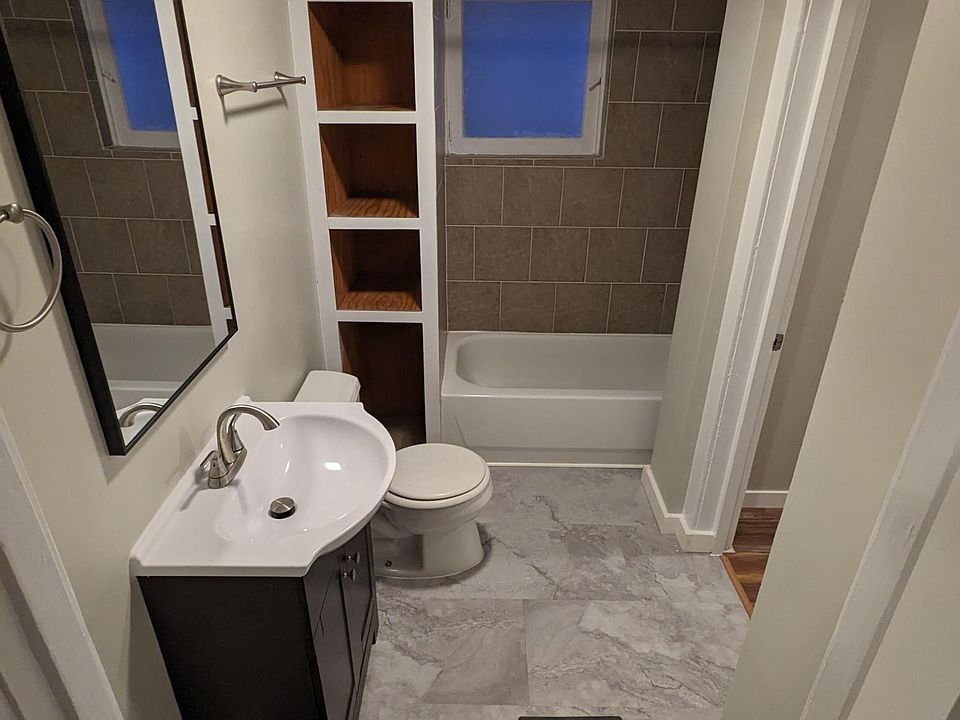 Bathroom with bonus room through doorway on the right through the bathroom. Picture taken while standing in living room.