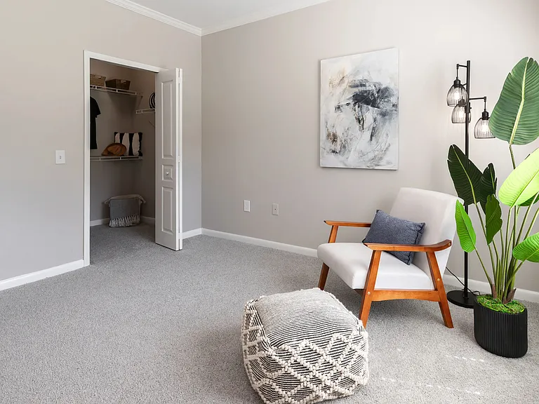 A blend of comfort and convenience, this bedroom features serene design elements, abundant natural light, and a walk-in closet with built-in storage.