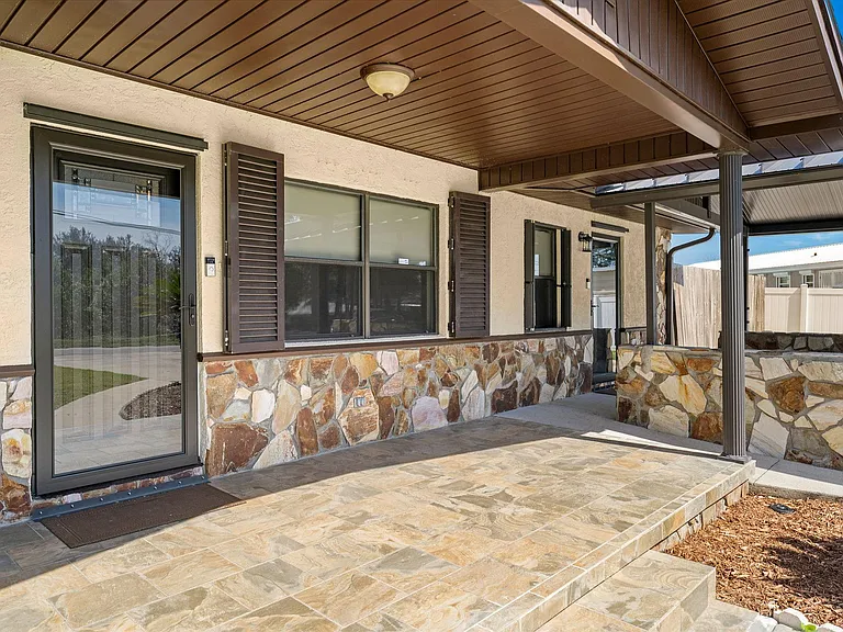 Covered front porch. New storm doors. Easy-operating hurricane shutters for all doors and windows.