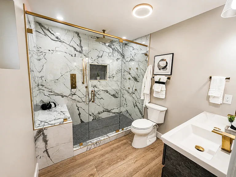 private in-suite master bathroom with double vanity and large marble shower with rain shower, 6 full body wall jets, or adjustable wand. Complete with built-in bench