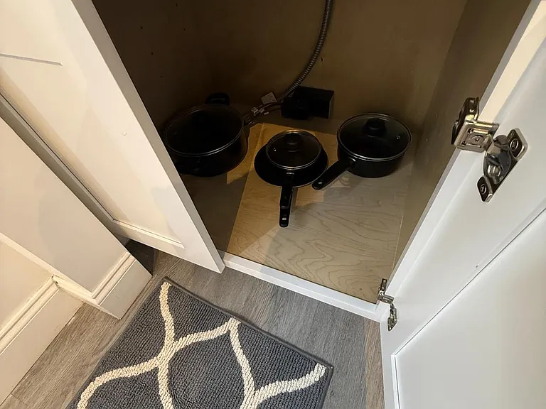 Equipped with pots, lids, and frying pans.