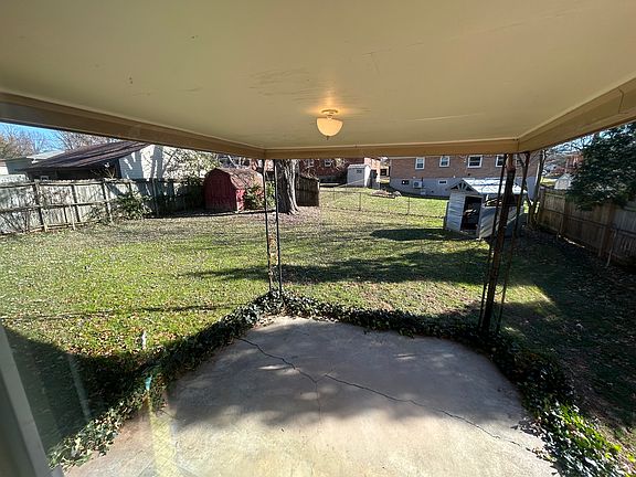 Back porch with ceiling fan and fenced backyard