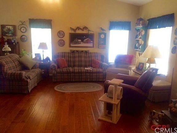 Wood plank flooring throughout the living and kitchen and hallways