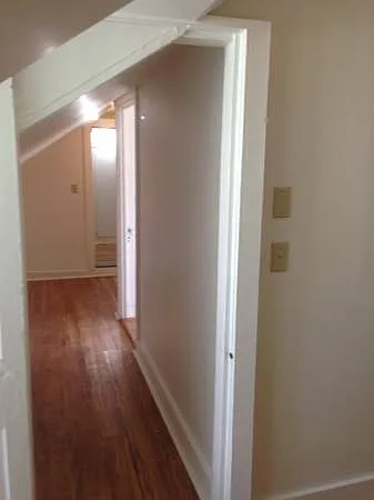 Hallway looking from smaller bedroom back towards stairs.