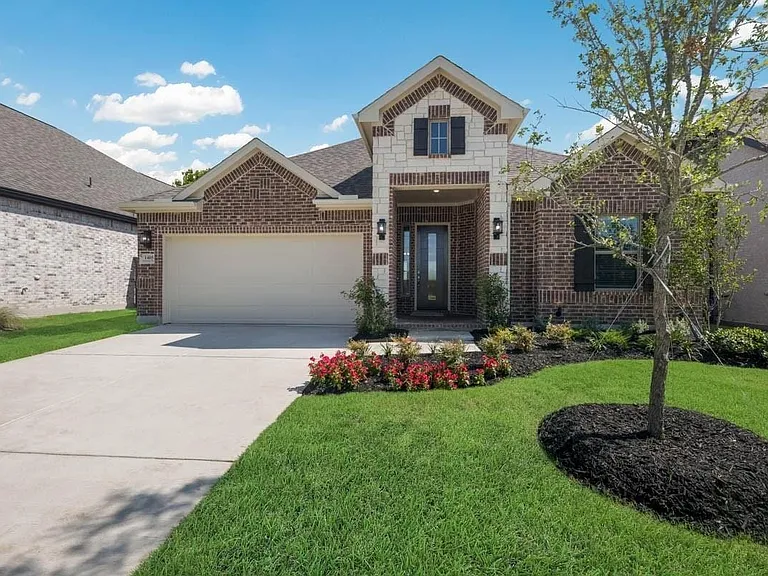 Brick and stone exterior with a two-car garage