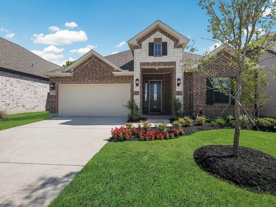 Brick and stone exterior with a two-car garage
