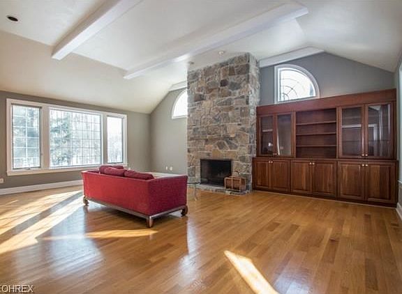 Great room with stone fireplace and souring ceilings
