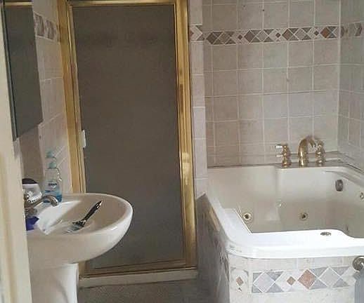 Bathroom w jetted tub and stand up shower