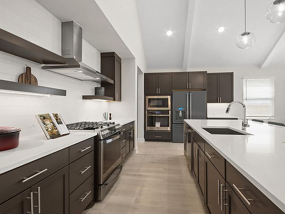 Kitchen with pendant lighting floating shelves