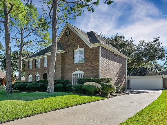 Notice the plethora of mature trees in and around this home, offering plenty of shade and a lush landscape.