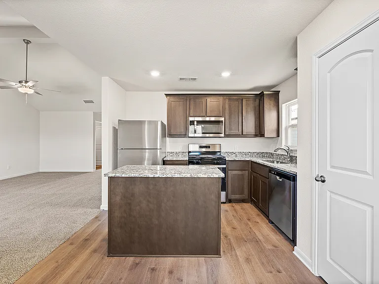 The kitchen of the Sabine has gorgeous wood cabinetry.
