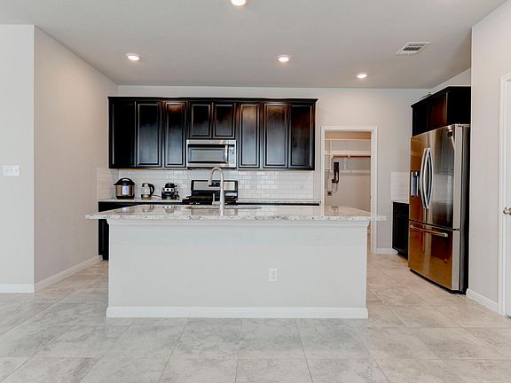 Kitchen with stainless steel appliances and pantry