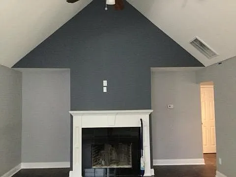 Living room with fireplace to the right are the upper level bedrooms and bathroom