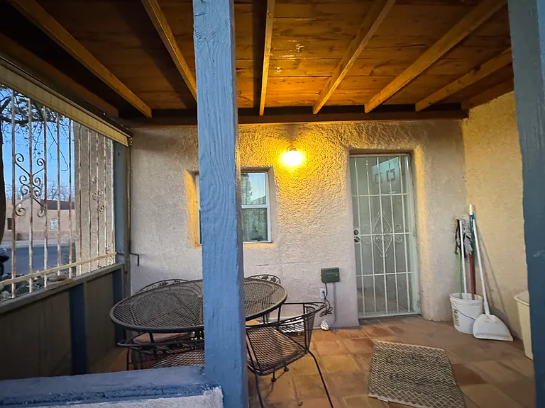 Spacious back porch for an additional hang out space. Rod iron patio set.