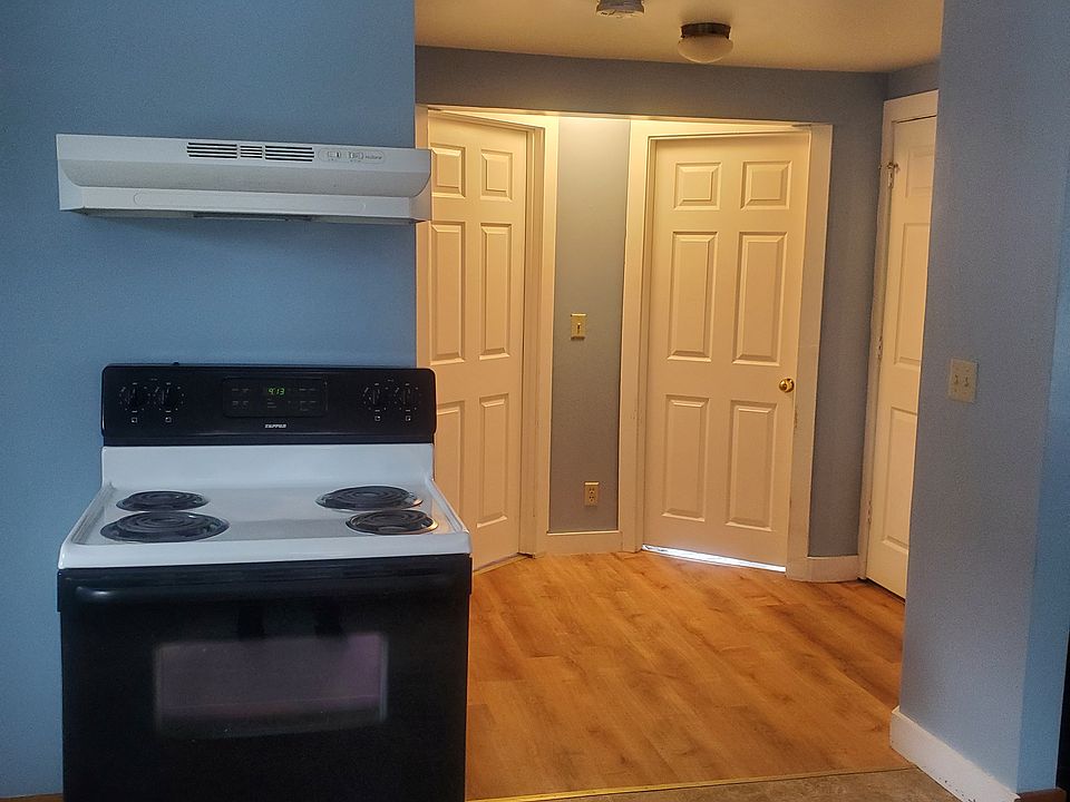 Entrance door on right, center doors to first floor bedroom and den off of kitchen