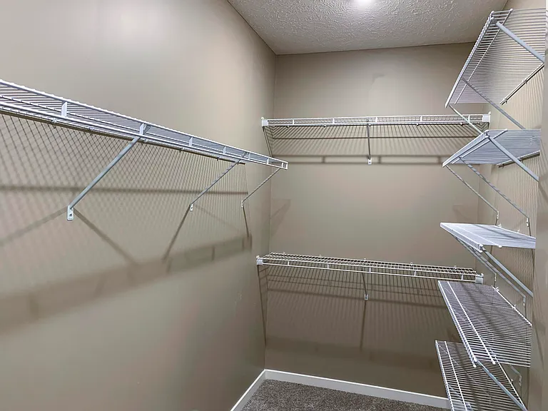 Enjoy the convenience of a walk-in closet with ample shelving and hanging space.