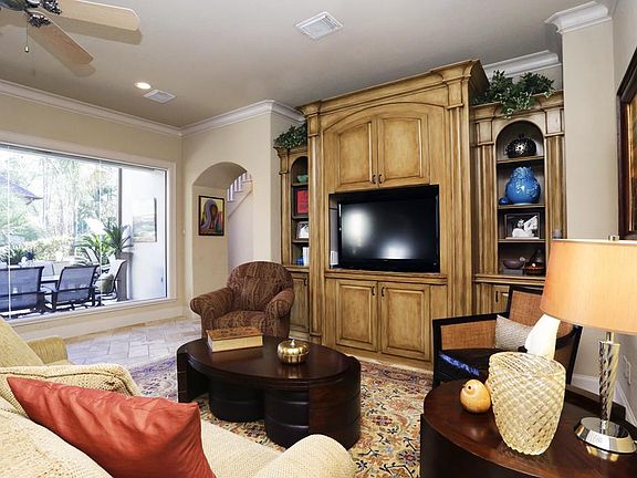 Family room with custom built-ins and herringbone-patterned Pavioi Antico limestone floors.