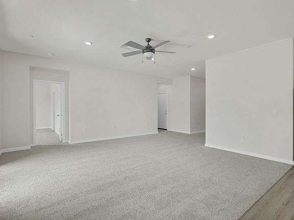 The family room is spacious with a ceiling fan.