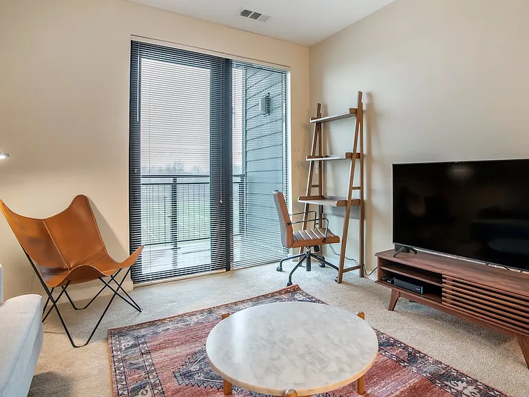 Furnished+ apartment homes come outfitted with a sofa, side chair, side table, coffee table, office chair, desk, TV stand and 50" Television (Representative Image exact items and style of furnishings may vary)